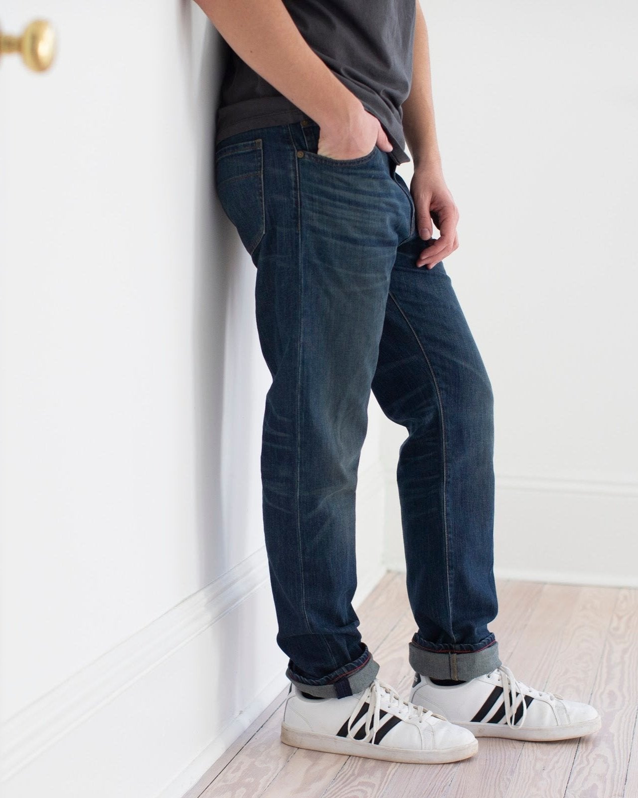 angle hover: 319 Wash | A model wears Raleigh Denim Workshop Alexander work fit jeans in the 319 wash, front view