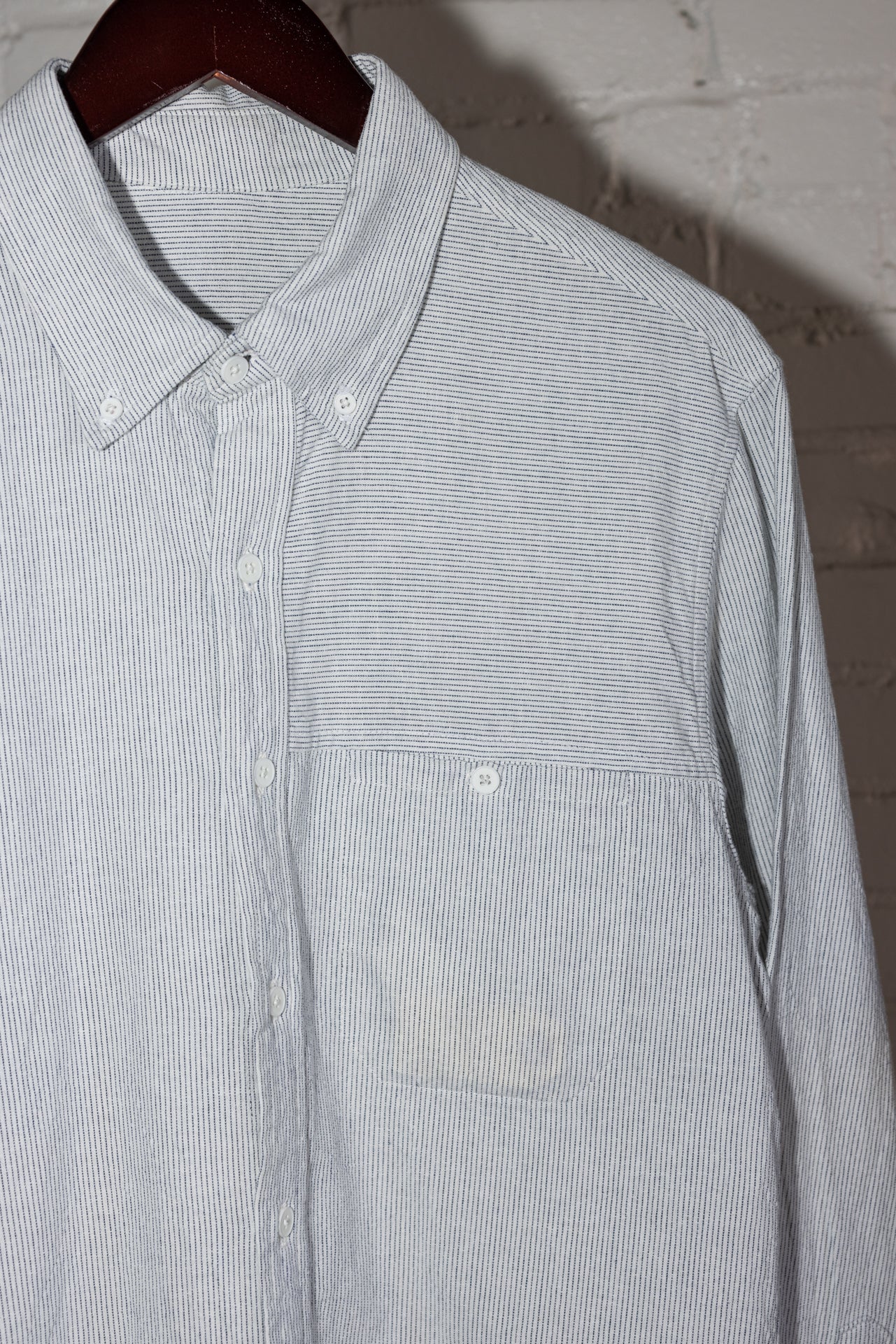 angle: Oxford Ticking Stripe: Man wears white oxford buttonup in ticking stripe