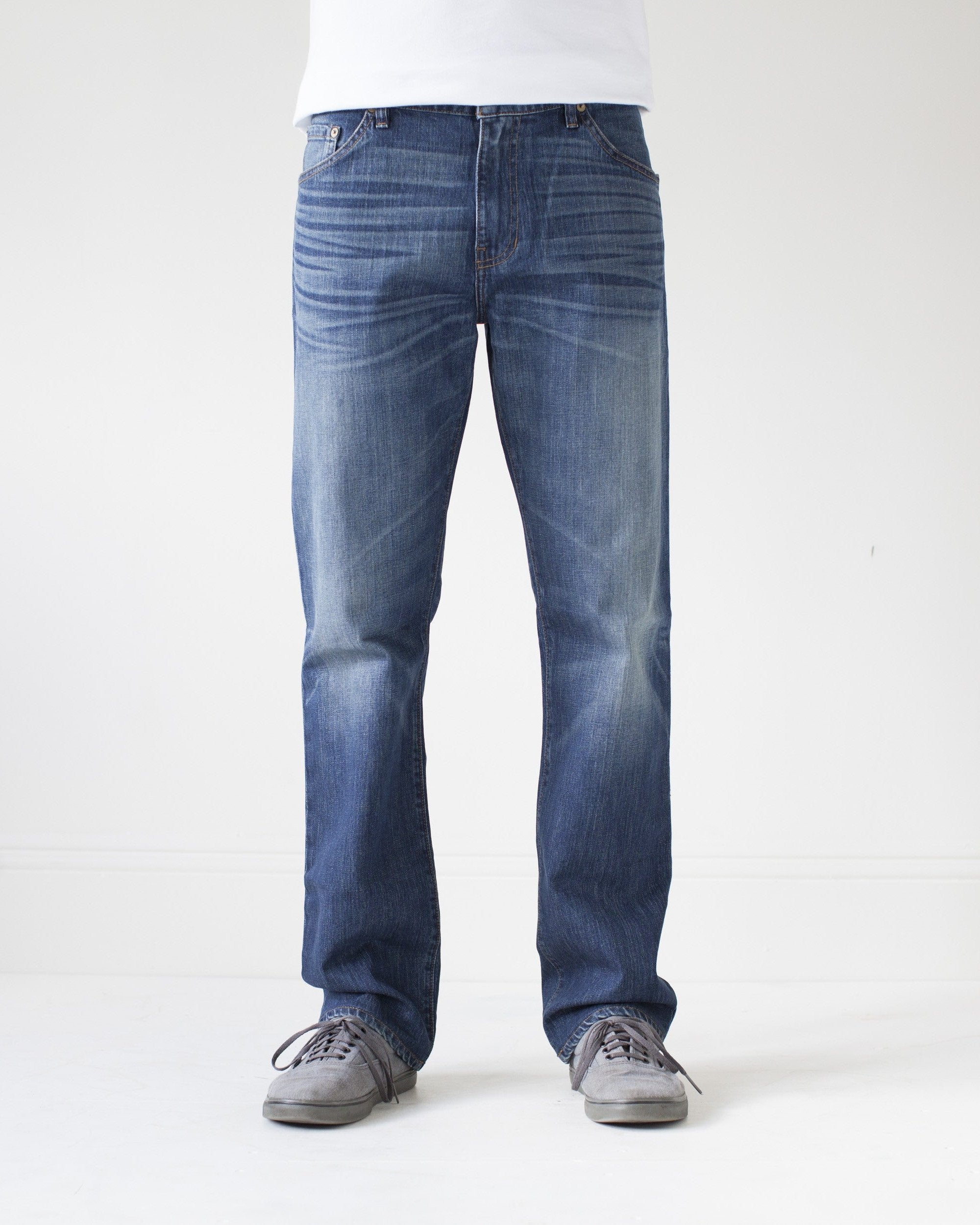 angle: 319 Wash | A model wears Raleigh Denim Workshop Alexander work fit jeans in the 319 wash, front view