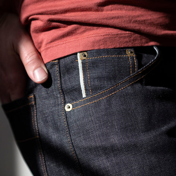 angle: 211 | A model wears Raleigh Denim Workshop Jones thin fit selvage raw jeans, front view