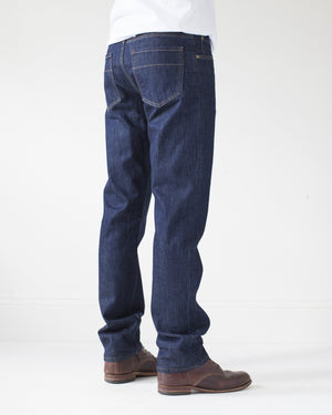 angle: resin rinse | A model wears Raleigh Denim Workshop Alexander work fit jeans with a dark wash, back view