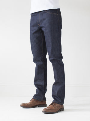 angle: 211 | A model wears Raleigh Denim Workshop Jones thin fit selvage raw jeans, side view