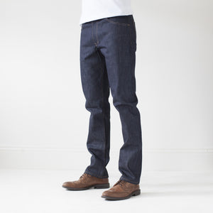 angle: 211 | A model wears Raleigh Denim Workshop Jones thin fit selvage raw jeans, side view