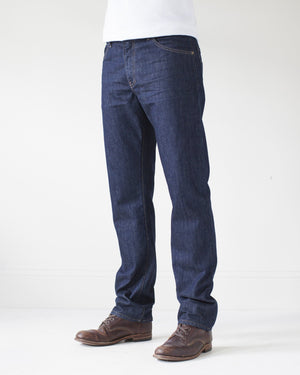 angle: resin rinse | A model wears Raleigh Denim Workshop Alexander work fit jeans with a dark wash, front view